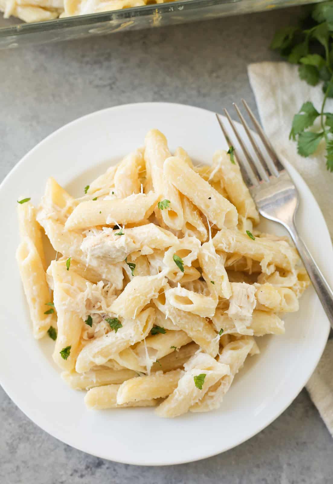overhead shot of chicken alfredo on a white plate