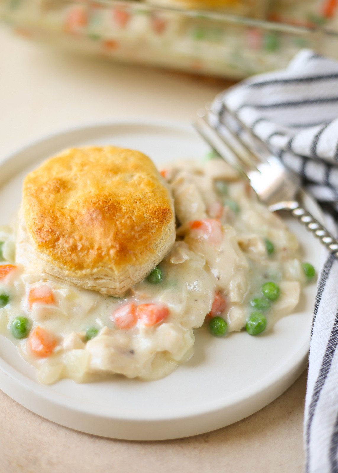 Chicken pot pie casserole with biscuits on top. 