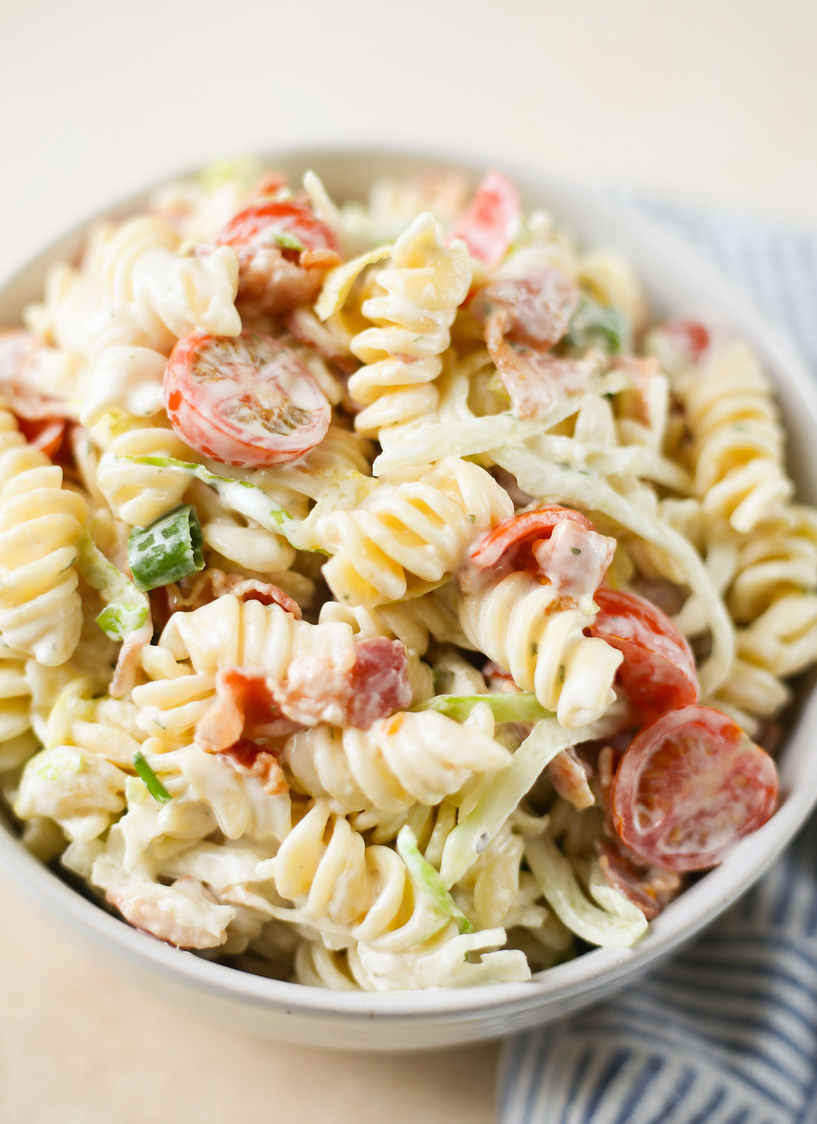 BLT pasta salad. It has pasta, bacon, toamtoes, green onions, shredded lettuce, and a creamy ranch dressing. 